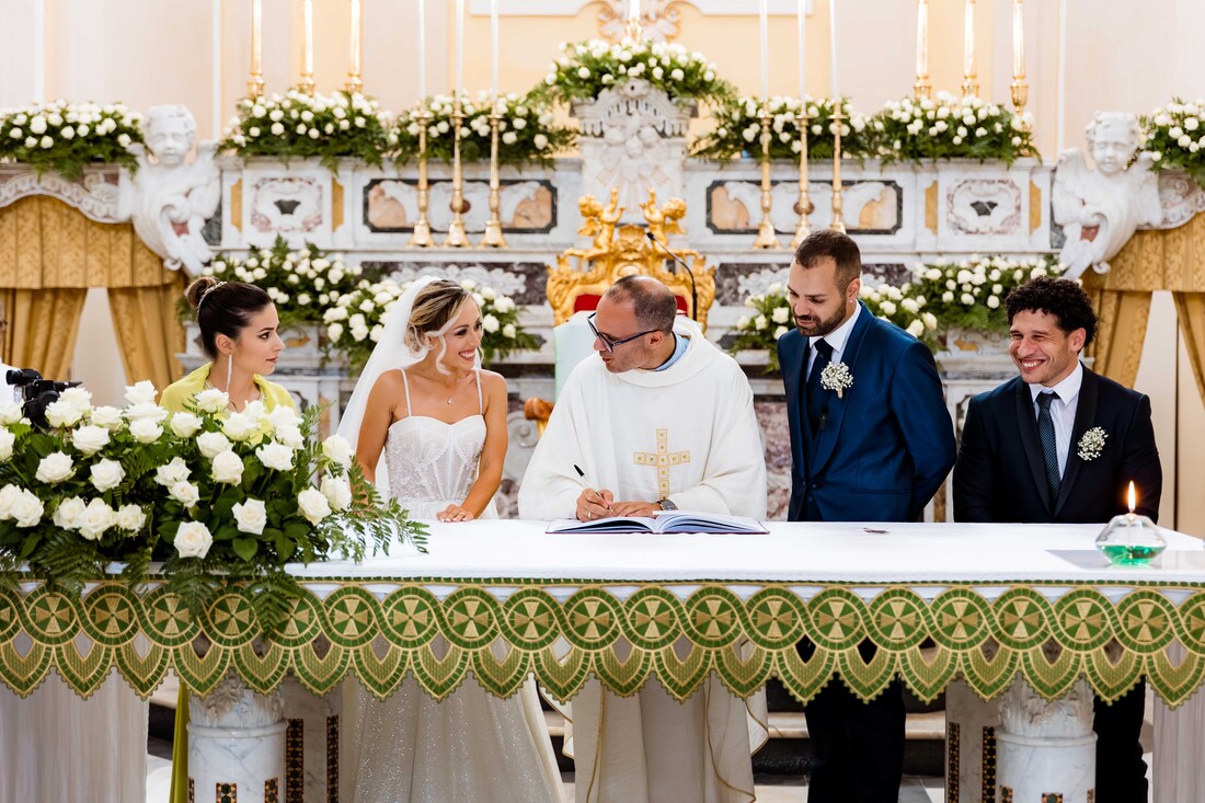 Momento legale: la coppia completa i formalità del matrimonio firmando i documenti in chiesa matteo picarella fotografo
